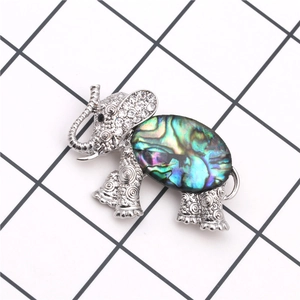 Detailed view of elephant brooch with rainbow abalone shell and sparkling crystals