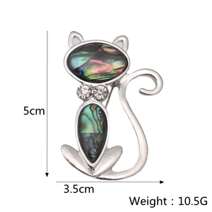 Detail view of cat brooch with colorful abalone shell inlay and measurements 5cm x 3.5cm