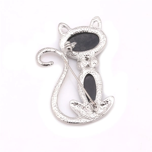 Macro view showing the pin fastener and hammered silver texture on the cat brooch back