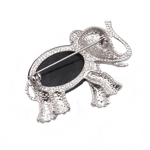 Detailed back view of elephant brooch with silver alloy texture and safety pin clasp