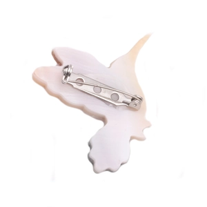 Detail view of the hummingbird brooch reverse side with secure silver metal safety pin