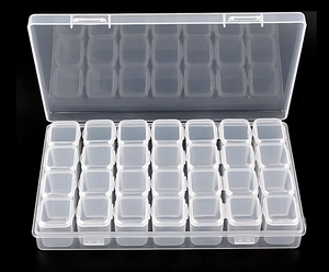 Detail view of 28-compartment clear plastic storage box for nail art and jewelry organizer