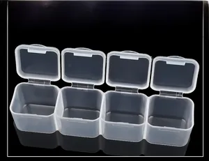 Detail of four-compartment transparent plastic jewelry storage box with individual lids