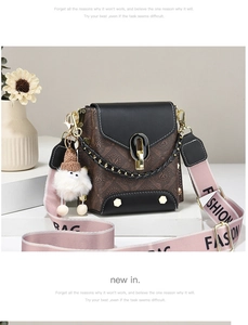 Close-up of brown patterned crossbody bag with pink fashion strap and plush charm