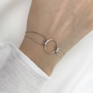 Detail view of a minimal S925 sterling silver double-strand snake chain ring bracelet