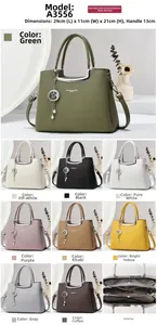 Internal view of the large leather handbag showing three spacious compartments and moon pendant