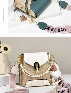 Detail of crossbody bag with monogram print, gold buckle, and plush sheep charm accessory