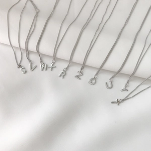Detailed row of 925 sterling silver necklaces featuring various initial letter pendants