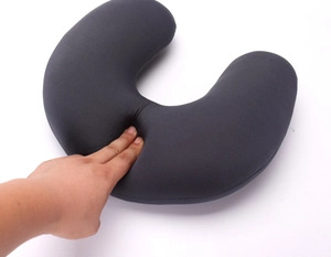Close-up of flexible dark gray U-shaped neck pillow showing soft texture and high resilience