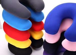 Detailed stack of multi-colored plush U-shaped travel pillows showing various color options