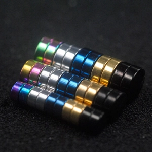 Magnetic stud earrings in multiple metallic colors including rainbow and gold on black texture