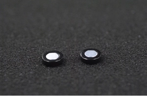 Macro shot of circular black magnetic earrings with silver metal magnets for non-pierced ears