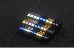 Close-up of magnetic stud earrings in gold, silver, black, blue and iridescent finishes