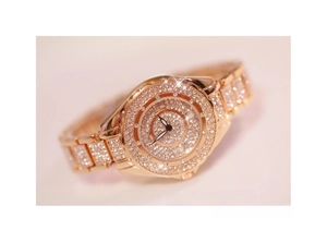 Detailed view of rose gold luxury watch featuring full crystal pavé on bezel and dial
