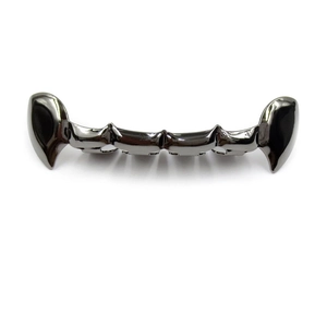 Macro view of gun metal hip hop vampire fangs grillz with polished plating and brackets