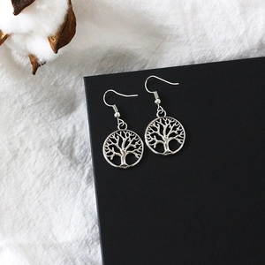 Detail shot of vintage silver Tree of Life earrings with intricate hollow design