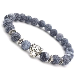 Black weathered agate beaded bracelet with silver alloy leopard head charm on white background