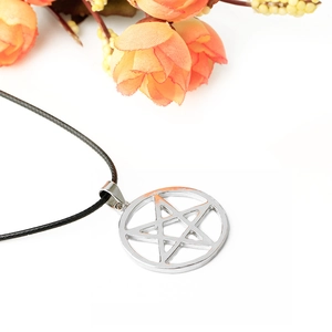 Silver star pendant necklace with black cord on white background with floral accents