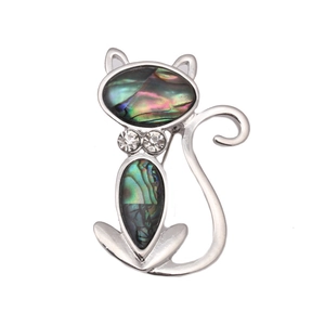 Silver cat brooch pin inlaid with natural abalone shell and white rhinestones on white background