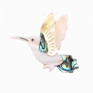 Hummingbird brooch with white shell and colorful abalone shell inlays on white background