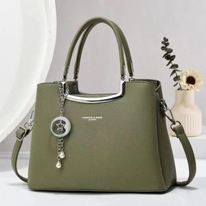 Elegant dark green lychee leather handbag with silver star moon charm and shoulder strap