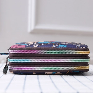 Detailed side view of the triple zipper floral canvas wallet showing large capacity storage