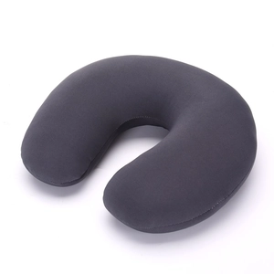 Detailed close-up of dark grey plush U-shaped travel neck pillow with knit fabric