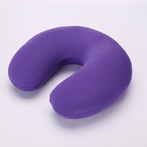 Detail view of purple plush fabric texture on ergonomic U-shaped travel neck pillow