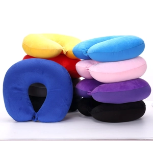 Detailed stack of multi-color plush U-shaped travel pillows on a white background