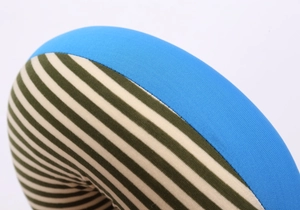 Detailed view of the stitching and texture of the blue and striped U-shaped travel pillow