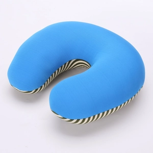 Detail of blue plush U-shaped neck pillow with green and white striped knit fabric side