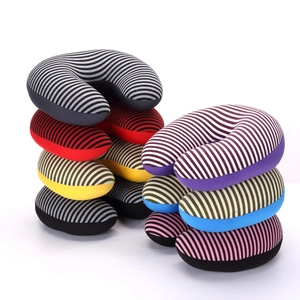 Close-up of stacked U-shaped travel neck pillows with colorful striped patterns