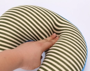 Close-up of green striped U-shaped neck pillow showing soft rebound and knit texture