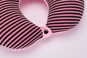 Top-down view of a pink and black striped U-shaped neck pillow with a snap button closure