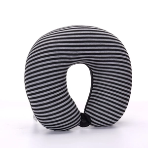 Macro detail of U-shaped neck pillow featuring black and grey stripes and secure buckle