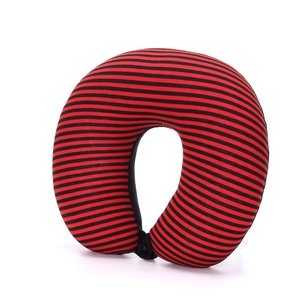 Detail of red and black striped U-shaped neck pillow with soft knitted cotton texture