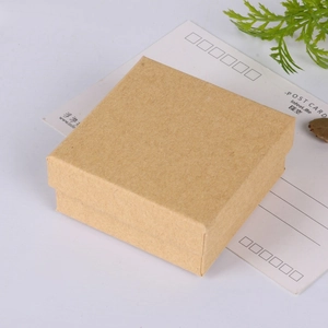 Detail of square brown kraft paper jewelry gift box with natural decorative leaves