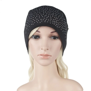 Detail shot of black knitted beanie featuring sparkling silver rhinestones and star-like pattern