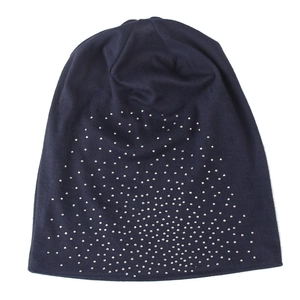 Detailed view of silver rhinestones on a navy blue knitted winter beanie for outdoor warmth