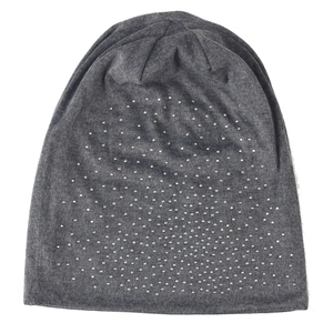Detail of dark gray beanie featuring sparkling silver rhinestones on knit fabric