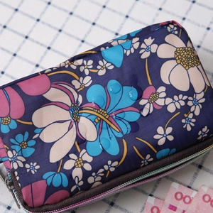 Close-up of waterproof canvas wallet with floral pattern and condensed water droplets