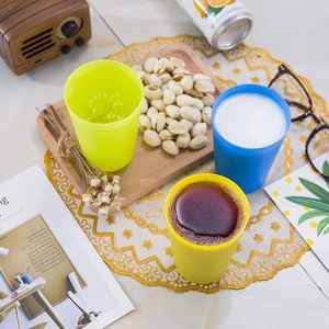 Close-up of colorful stacking cups in blue, yellow and green on a styled table