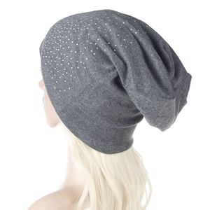 Detail of grey slouchy beanie with rhinestones on soft knit fabric for winter warmth