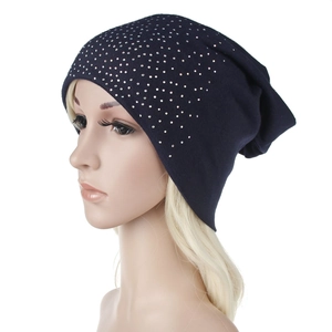 Close-up of dark blue knitted beanie with sparkling silver rhinestones for winter