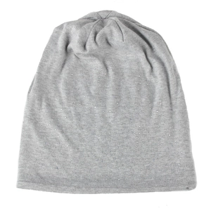 Detail shot of light grey knit beanie with scattered sparkling rhinestones on white background