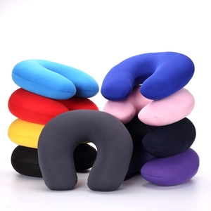 Detailed pile of multi-color U-shaped travel pillows showing various vibrant fabric options