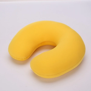Detail view of bright yellow U-shaped travel neck pillow in soft elastic fabric
