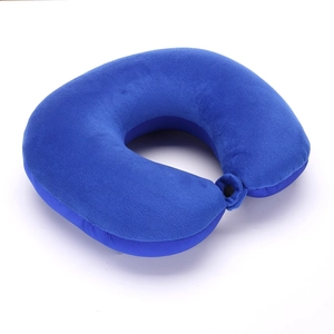 Detail view of blue plush U-shaped travel neck pillow with secure snap fastener closure
