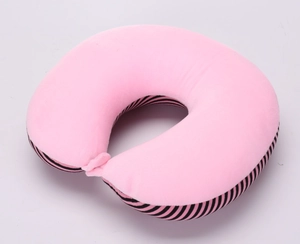 Pink velvet U-shaped travel neck pillow with black and white striped decorative side detail