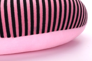 Close-up of pink and black striped plush fabric showing soft texture and fine stitching